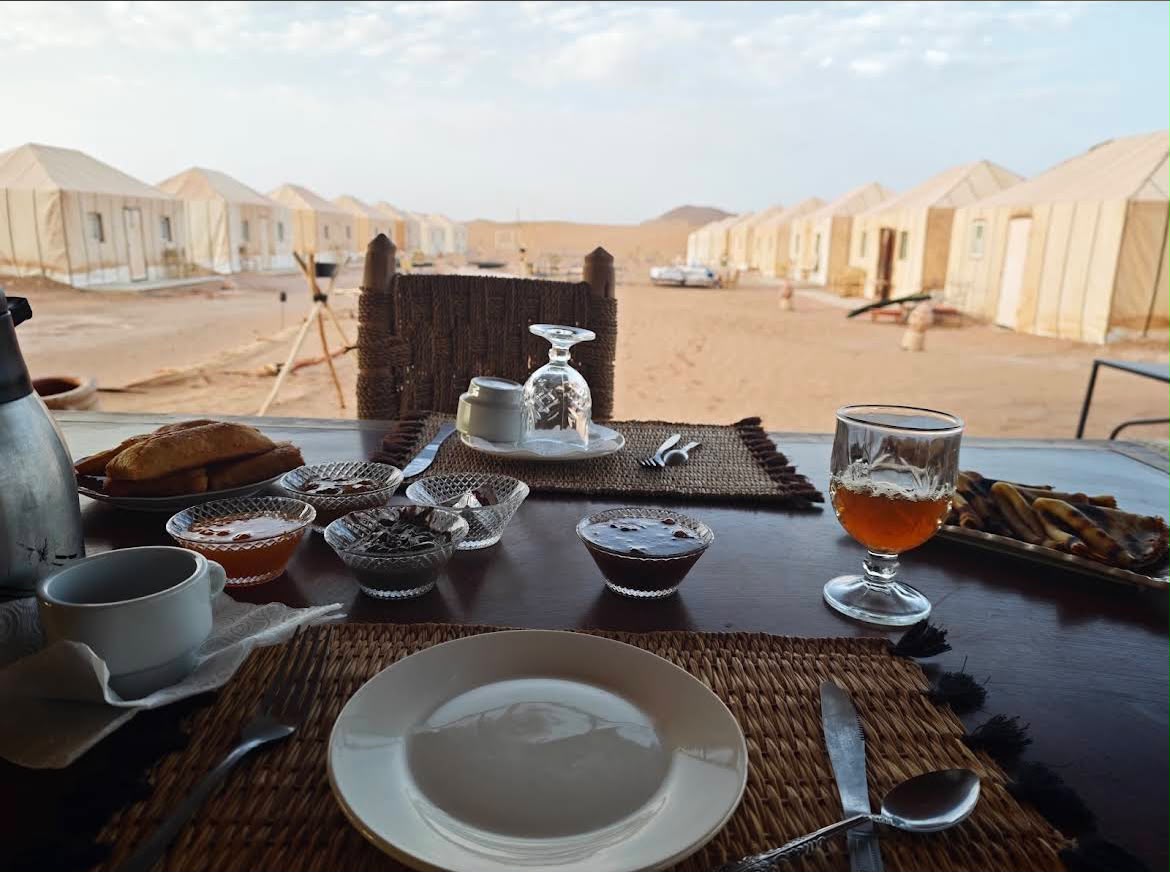 Breakfast table overlooking luxury camp tents
